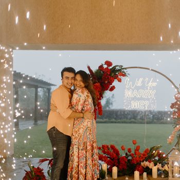 Set in the lap of nature and surrounded by scarlet blooms, this wedding proposal looked straight out of a fairytale!