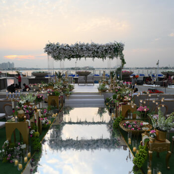 Fresh white blooms, a chrome aisle and Dubai’s coastline set the stage for this striking phera ceremony!