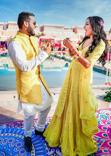 Photo Of A Couple In Coordinated Yellow Outfits For Their Mehndi