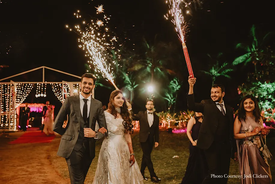Bride wearing off-white gown by Gaurav Gupta and groom wearing three peice suit by Govinda Mehta