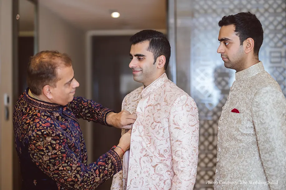 Groom in ivory sherwani with intricate embroidery in blush pink